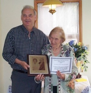 John Hatfield, President of the Heritage Society from 2005-2015, presenting donor recognition plaque to Elsie Schroeder